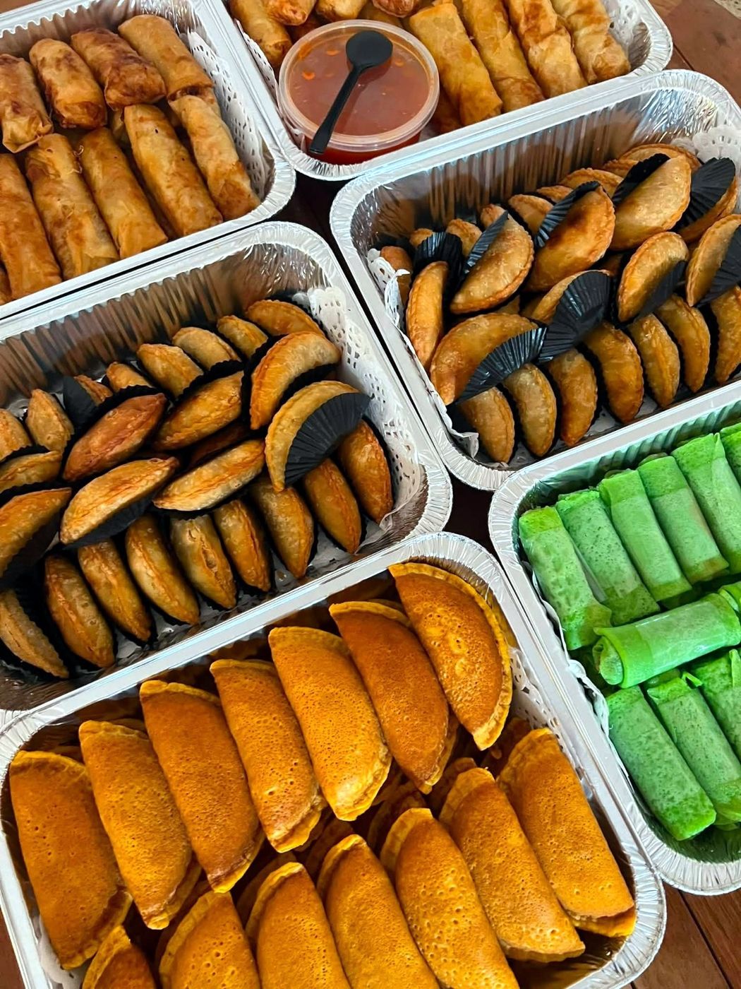 Trays of curry puffs, spring rolls and traditional kuih