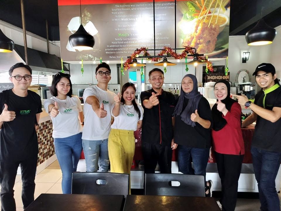 The Madli's team and regular customers together in the restaurant