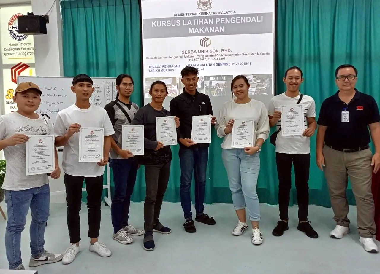 Madli's team members receiving their food handling course certificates